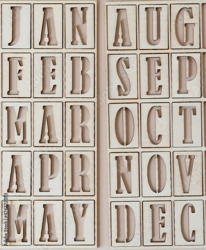 Foto the months jan to may and aug to dec in stencil font on paper
