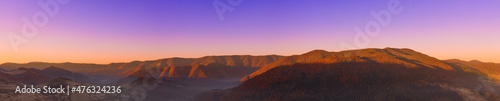 Autumn mountain landscape panorama. Peaks above the fog. Drone view. © maykal