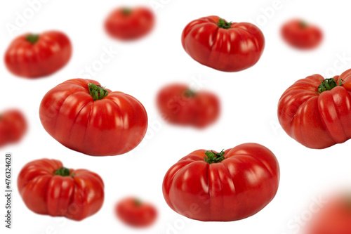 Tomatoes falling down, isolated on white background.