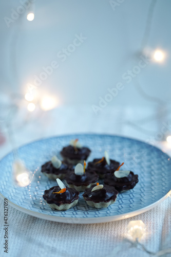 Typical czech christmas candy, still life with homemade confectionery decorated with flowers, with lights in the background, xmas mood, pot marrigold photo