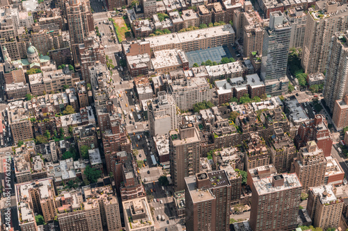 Aerial top view of New York City building roofs. Bird s eye view from helicopter of cityscape metropolis infrastructure  traffic  residential district and yellow cabs moving along streets and avenues