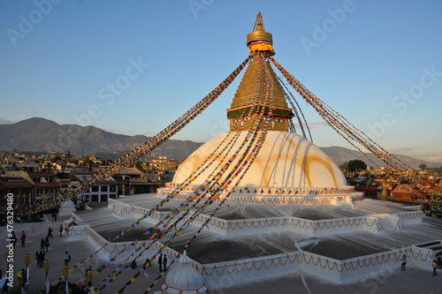 Festooned with colorful prayer flags  the Tibetan Buddhist stupa of Boudhanath  with its all-seeing eyes  glows in late-afternoon light  Kathmandu  Nepal