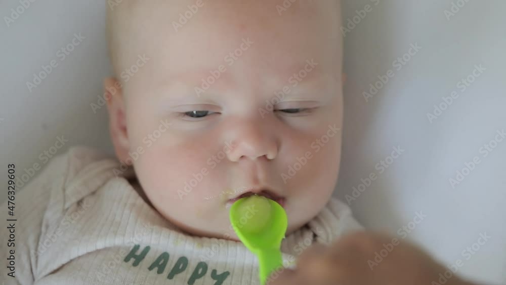 Infant baby eat porridge, first feeding Infant baby eat porridge, first feeding