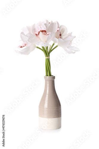 Vase with bouquet of beautiful orchid flowers on white background