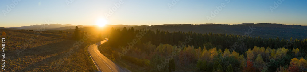 Paved road in the mountains. Autumn landscape at sunset.