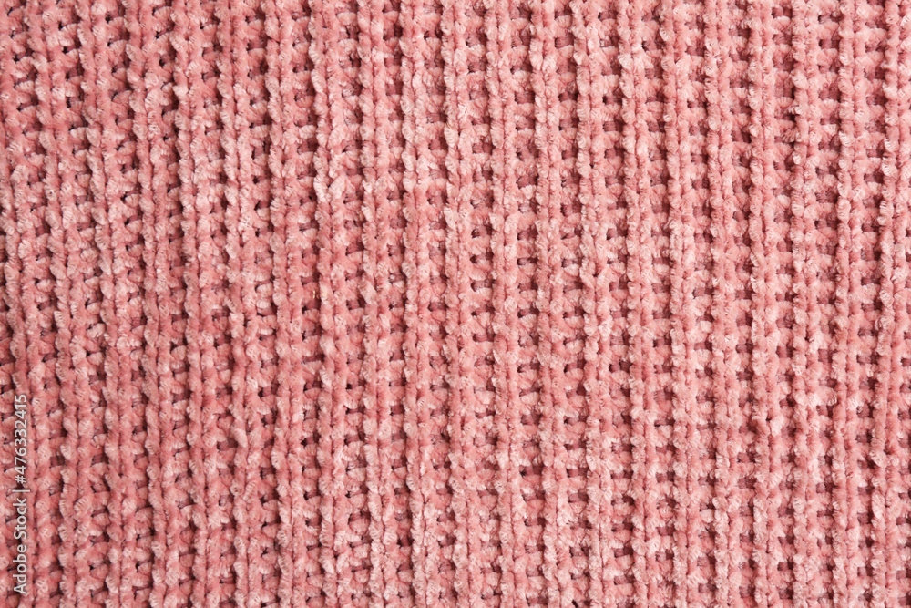 Beautiful pink knitted fabric as background, top view Beautiful pink knitted fabric as background, top view