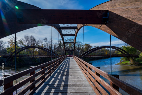 The Tridge is a three-way wooden footbridge that spans the Chippewa and Tittabawassee Rivers in donwtown Midland, Michigan, in Chippewassee Park. photo