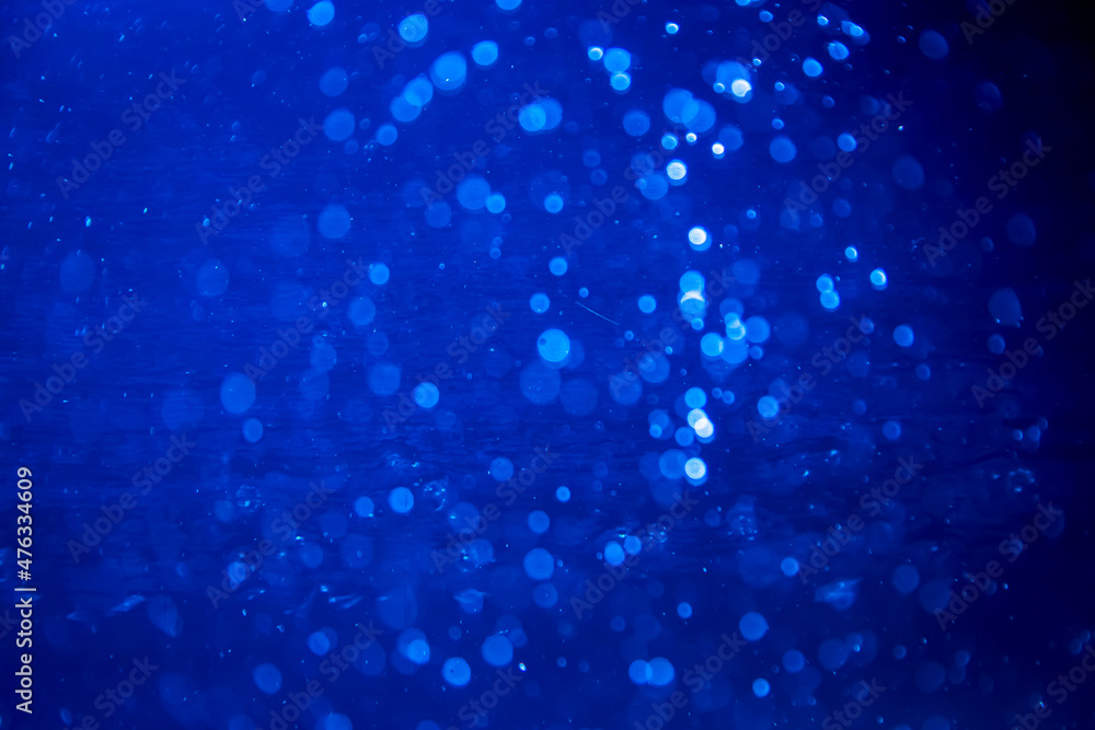 Abstract blur blue sparkle bokeh with black background Abstract blur blue sparkle bokeh with black background