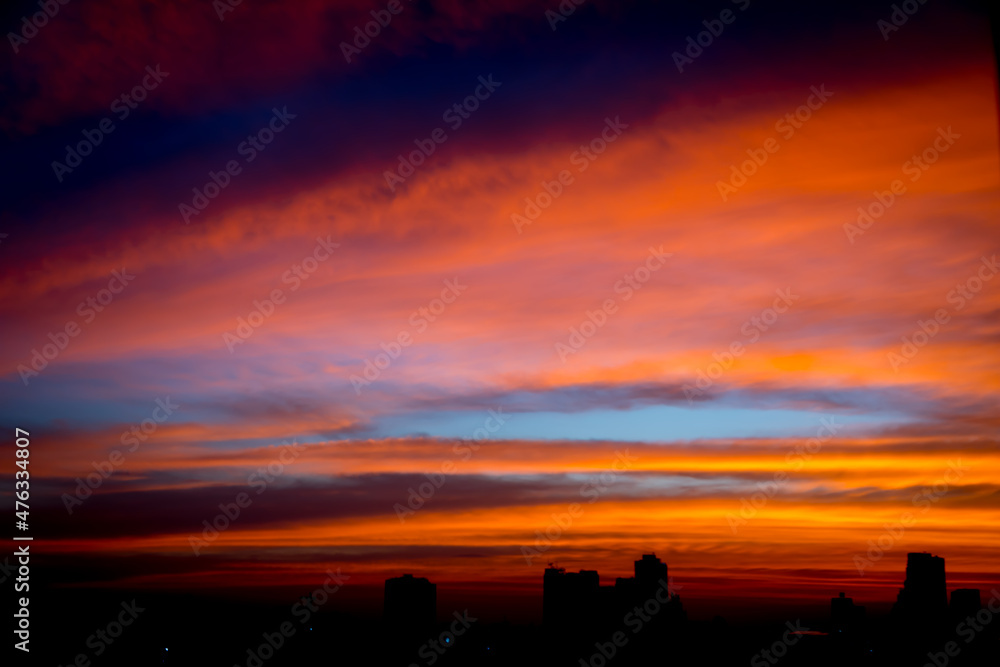 Blur image of Sunset sky with city in the shadow