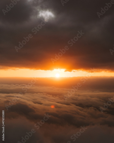 sunburst between clouds during a beautiful sunset © Jean