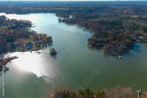 a stunning aerial shot of the Catawba River surrounded by vast miles of green and autumn colored trees with blue sky and clouds in Charlotte North Carolina USA	 photo