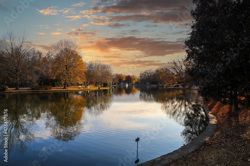 a stunning shot of a still lake in the park surrounded by gorgeous autumn colored trees reflecting off the water at sunset at Freedom Park in Charlotte North Carolina USA photo