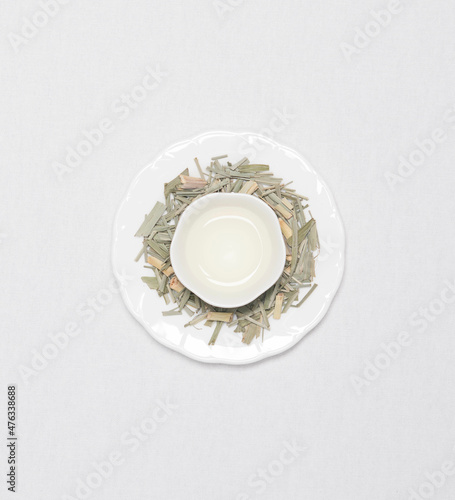 a cup of flower tea with dried flower tea leaves around