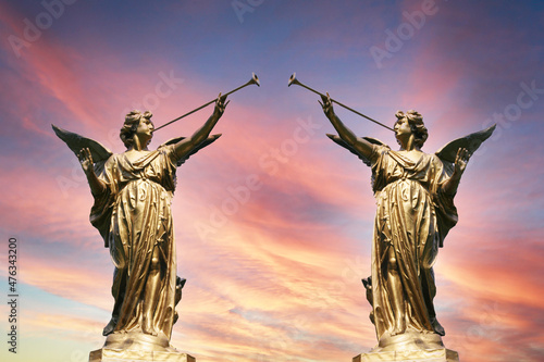 Two statues at the entrance to the cemetery promise paradise photo