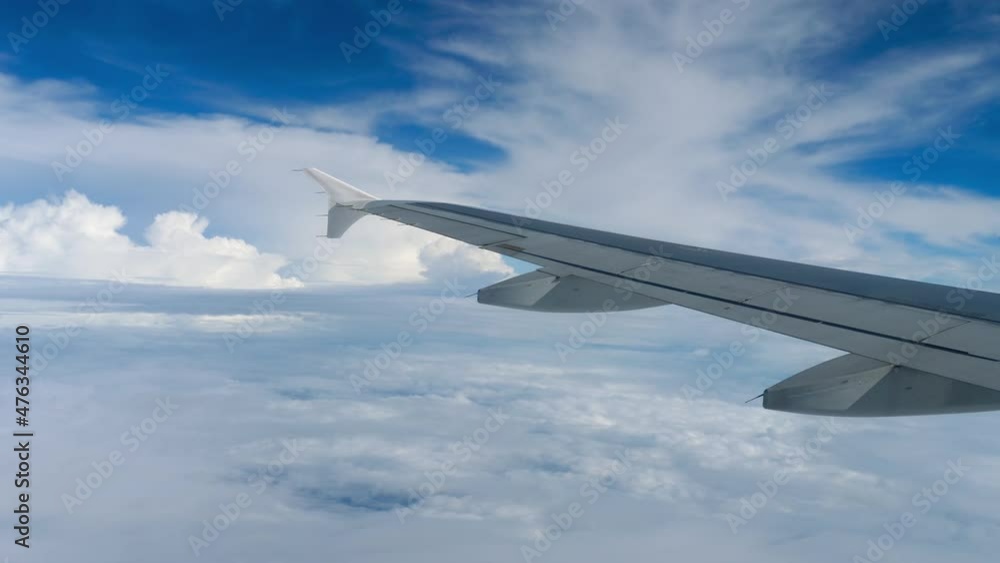 Airplane wing view against blue sky Airplane wing view against blue sky