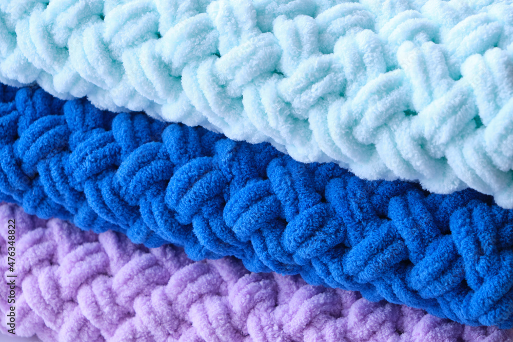 Background, warm, delicate and plush handmade baby blankets in colors of blue, lilac and mint. Background, warm, delicate and plush handmade baby blankets in colors of blue, lilac and mint.