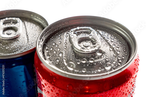 Close-up of a blue and red can of sweet drinks on a white background. Water droplets on the surface of the metal. Top view.