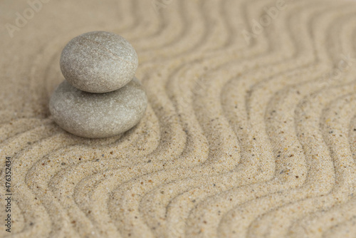 Zen sand garden meditation stone background with copy space. Stones and lines drawing in sand for relaxation. Concept of harmony, balance and meditation, spa, massage, relax