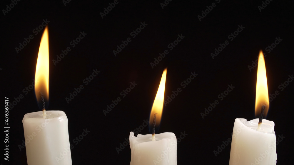 Shooting of burning a three candles on dark background Shooting of burning a three candles on dark background