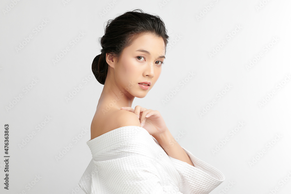 Beautiful young Asian woman wearing bathrobe on white background, Face care, Facial treatment, Cosmetology, beauty and spa Concept. Beautiful young Asian woman wearing bathrobe on white background, Face care, Facial treatment, Cosmetology, beauty and spa Concept.