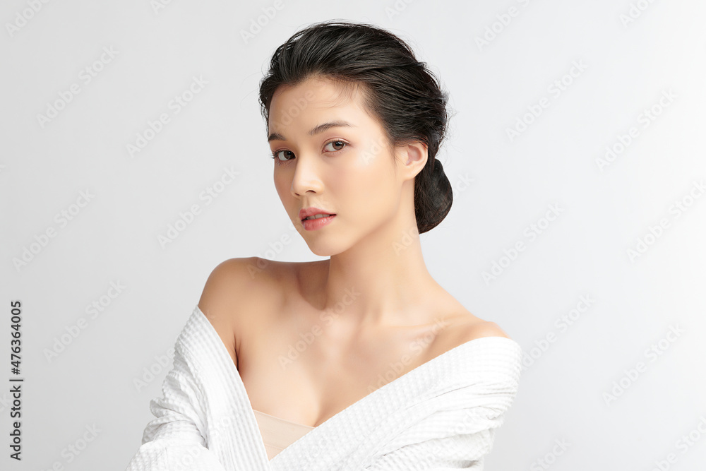 Beautiful young Asian woman wearing bathrobe on white background, Face care, Facial treatment, Cosmetology, beauty and spa Concept. Beautiful young Asian woman wearing bathrobe on white background, Face care, Facial treatment, Cosmetology, beauty and spa Concept.