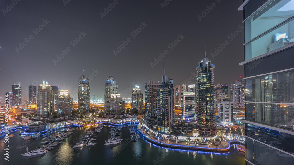 Luxury yacht bay in the city aerial night timelapse in Dubai marina