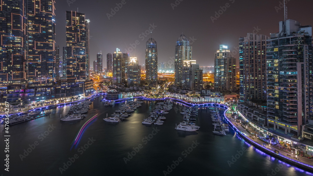 Luxury yacht bay in the city aerial all night timelapse in Dubai marina