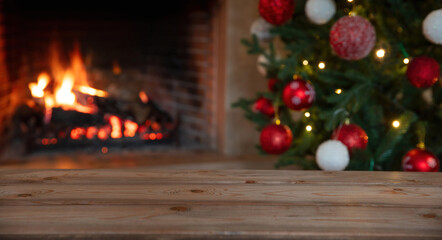Christmas tree and burning fireplace background. Wooden table desk empty, template