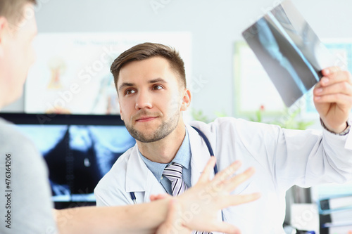 Smiling doctor talking with patient about good x ray results