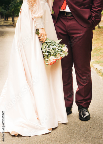 Wedding bouquet with roses in the hands of the bride