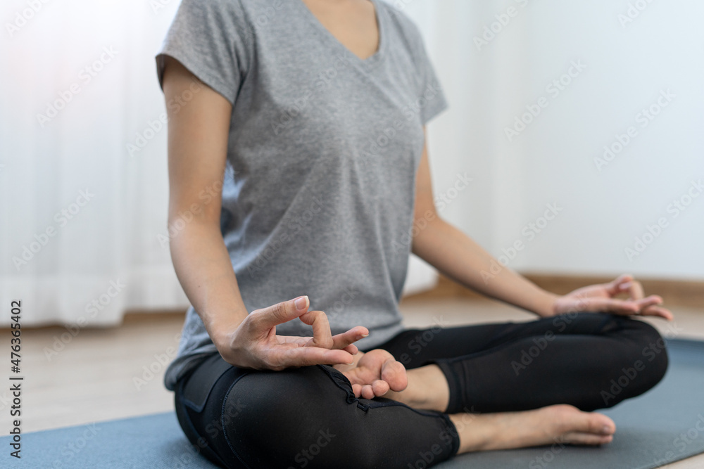 Young beautiful woman practicing yoga at home. Young beautiful girl doing exercises at home. balance, meditation, relaxation, healthy lifestyle concept