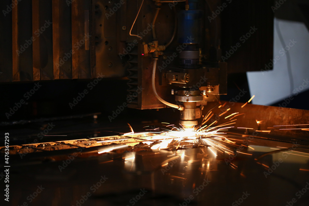 Cutting machine in work and metal plate, sparks fly of machine head