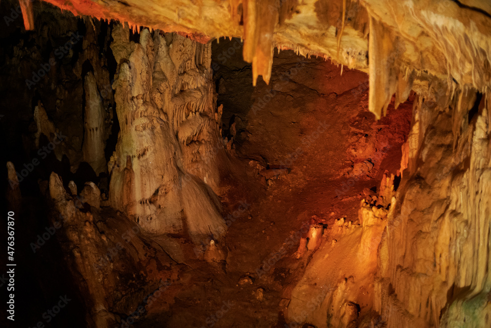 fabulous abstract background of stalactites, stalagmites and stalagnates in a cave underground, horizontal