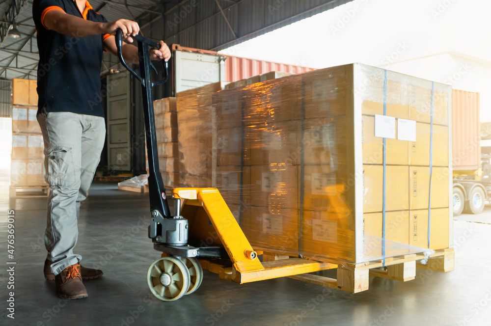 Workers Courier Using Hand Pallet Jack Unloading Package Boxes into Cargo Container. Delivery Shipment Boxes. Trucks Loading at Dock Warehouse. Supply Chain. Warehouse Shipping Transport Logistics. Workers Courier Using Hand Pallet Jack Unloading Package Boxes into Cargo Container. Delivery Shipment Boxes. Trucks Loading at Dock Warehouse. Supply Chain. Warehouse Shipping Transport Logistics.