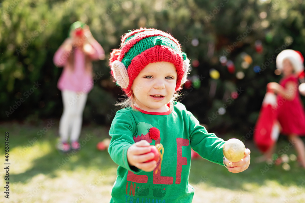 Christmas in july. children elf ears. Child waiting for Christmas in wood in july. portrait of little girl decorating christmas tree. winter holidays and people concept. Happy Holidays. Christmas in july. children elf ears. Child waiting for Christmas in wood in july. portrait of little girl decorating christmas tree. winter holidays and people concept. Happy Holidays.