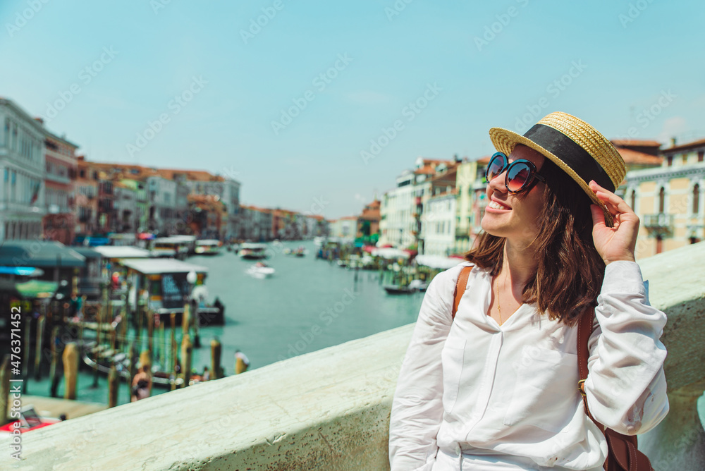 woman portrait in sunny summer day grand canal venice italy on background