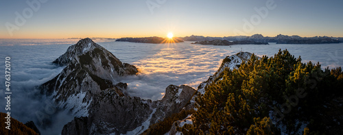 Berchtesgaden Alps at sunrise over a sea of clouds, Zwiesel summit cross, Bad Reichenhall, Bavaria, Germany photo