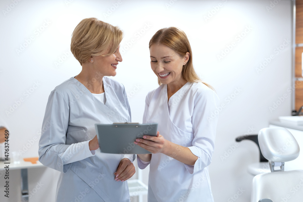 Family doctor and nurse checking patient records Family doctor and nurse checking patient records