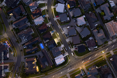 Aerial drone birds-eye view during the night evening looking down over a suburn in the city of Hamilton (Kirikiriroa), in the Waikato region of New Zealand (Aotearoa)
