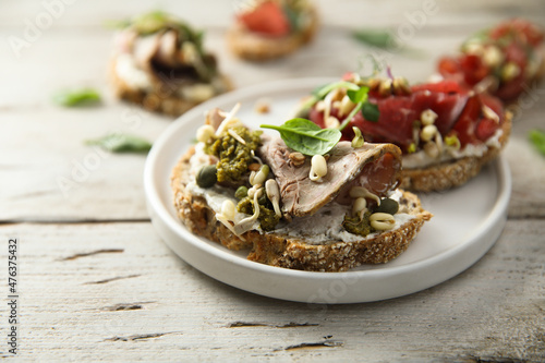 Homemade bruschetta with meat and cream cheese