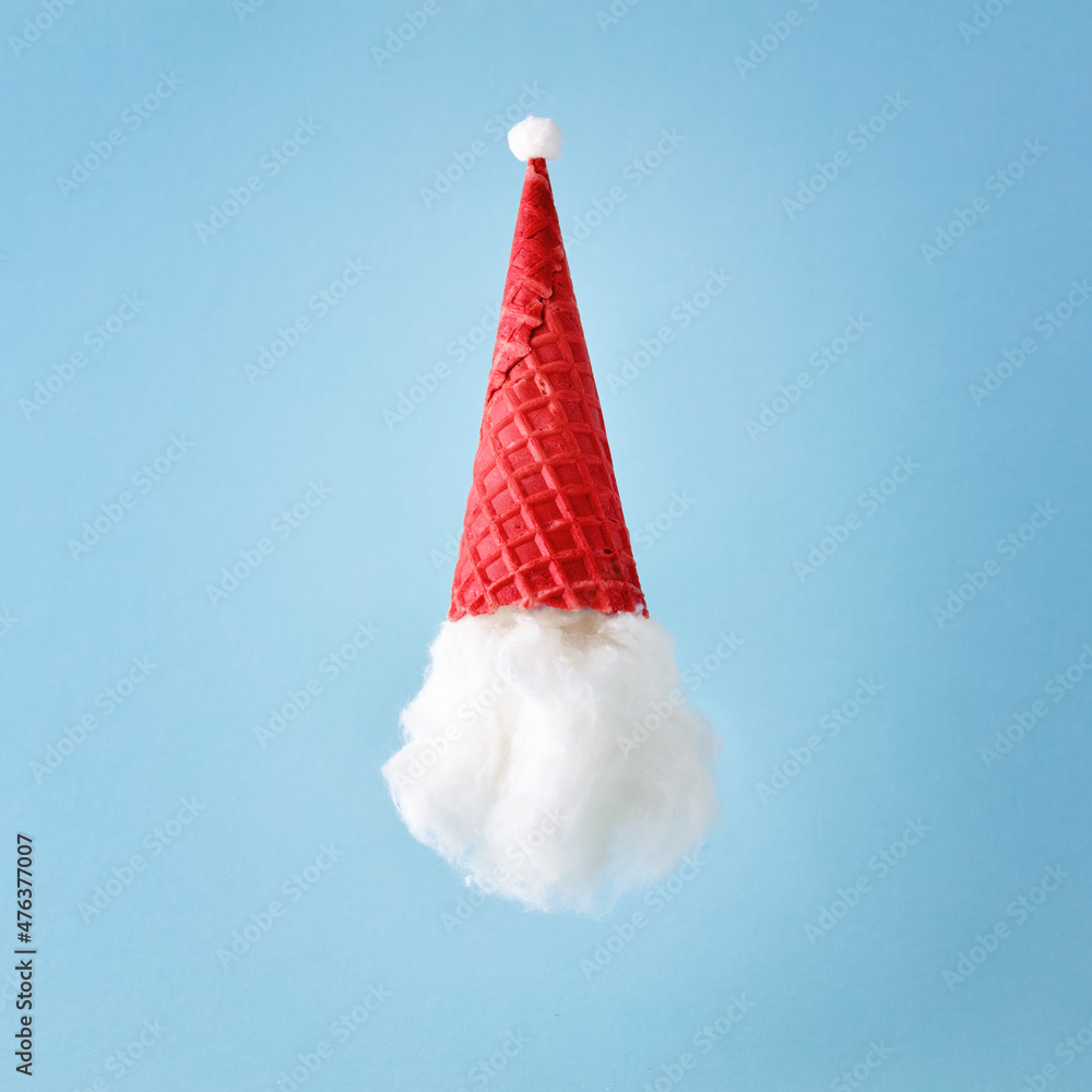 Santa Claus with a hat made of ice cream cone and cotton. New Year or Christmas holiday party Santa Claus with a hat made of ice cream cone and cotton. New Year or Christmas holiday party