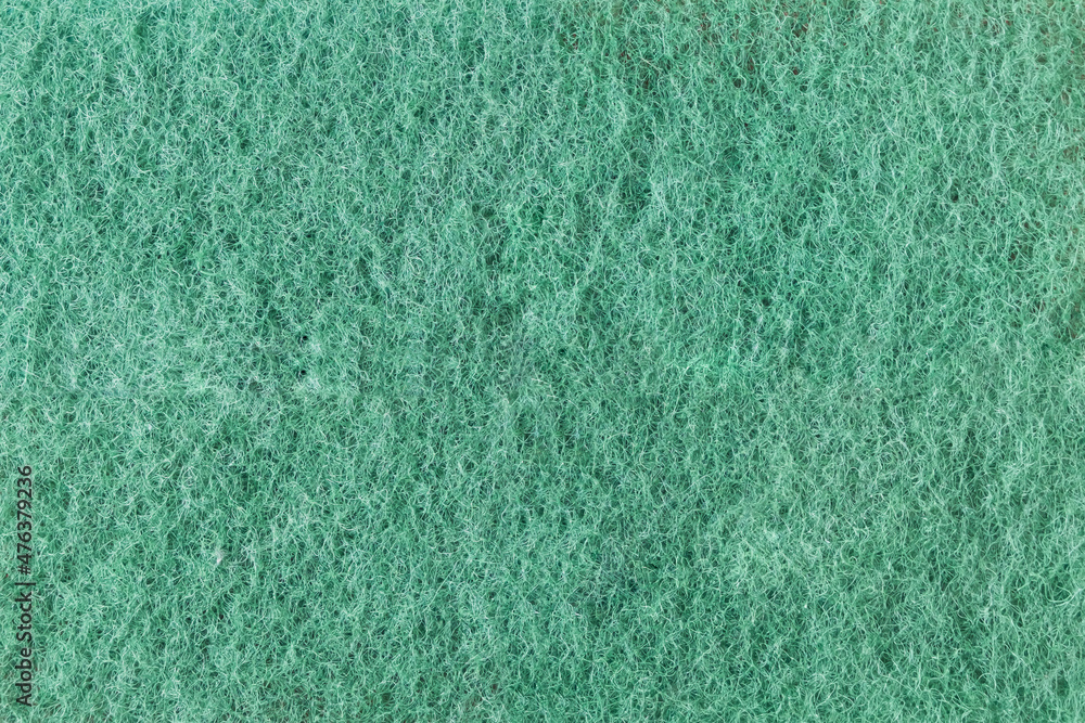 Green texture from the surface of the back of the foam sponge close-up. Textured background. High quality photo Green texture from the surface of the back of the foam sponge close-up. Textured background. High quality photo