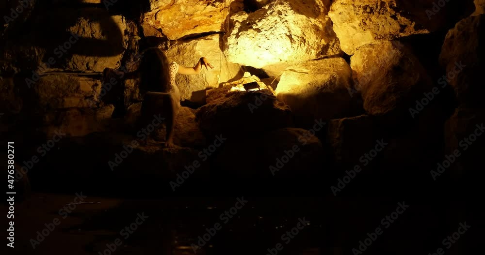 Child enjoy warm night sea. A child makes shadows on the wall by the sea waves during summer holidays. Child enjoy warm night sea. A child makes shadows on the wall by the sea waves during summer holidays.