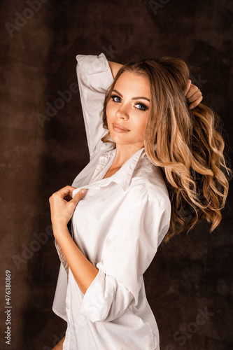 Portrait of a girl in a shirt on a dark background
