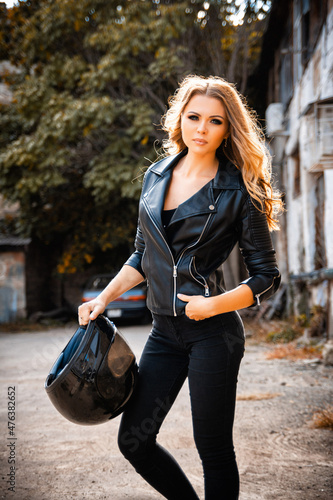 Portrait of a girl biker with a helmet on the street