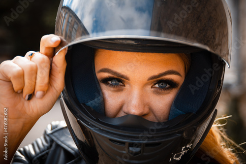 Portrait of a girl biker with a helmet on the street © Haibullaev