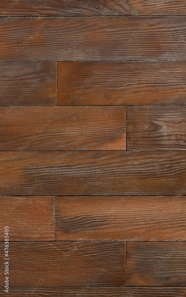 Obraz premium Beautiful wall of dark brown wooden planks, vertical image, texture and background.