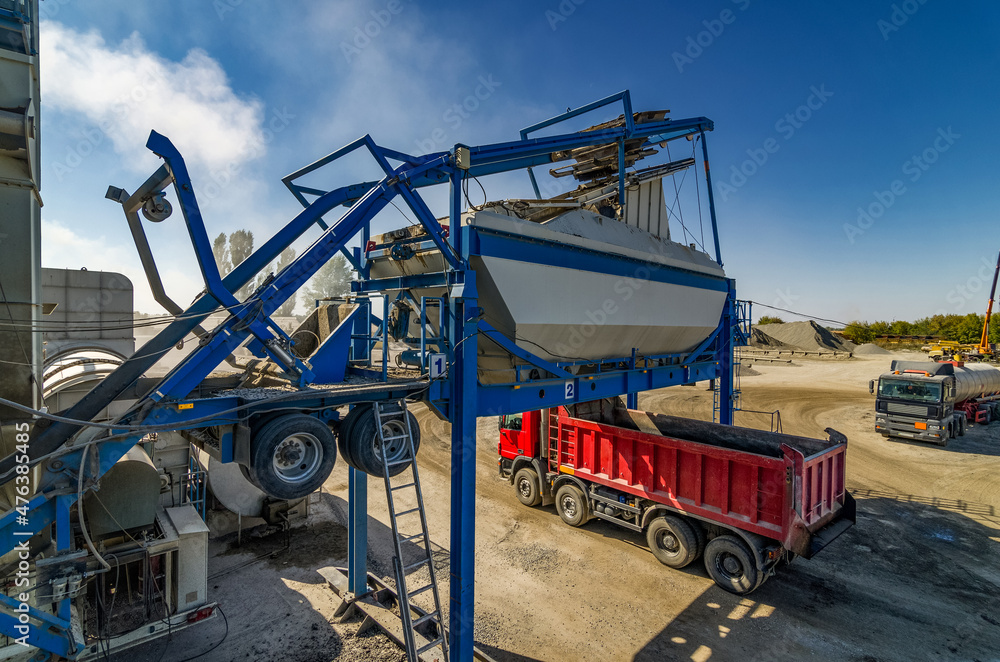 Mobile asphalt-concrete plant. Loading the red dumper.