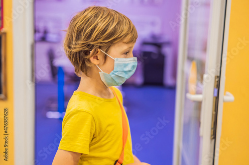 Schoolboy with protect mask on face. Face mask for protection coronavirus outbreak. Medicine healthcare mask. Coronavirus epidemic. Boy with protection mask. Kid in school. Coronavirus concept