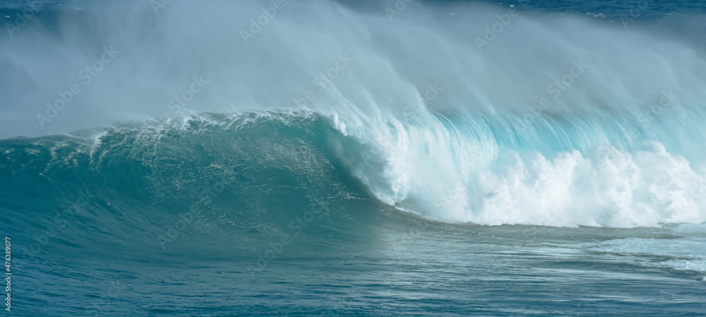 Sport photography. Jaws swell on International surfing event in Maui, Hawai 2021 December.